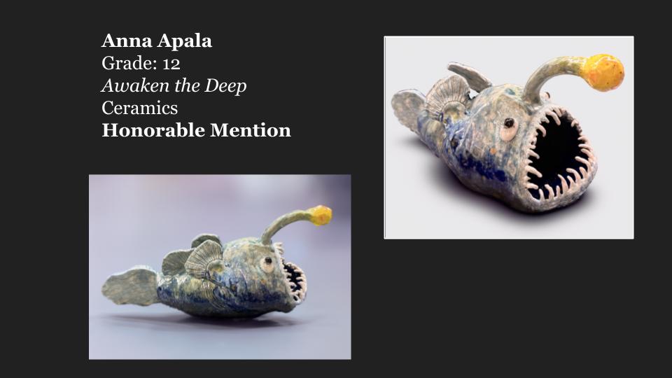 Ceramic fish artwork titled 'Awaken the Deep' by Anna Apala, featuring an exaggerated design with sharp teeth and an illuminated lure.