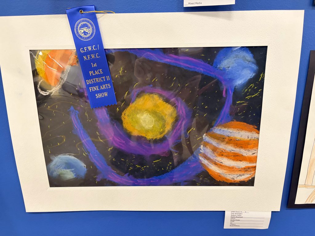 A colorful artwork depicting a planetary scene with various planets and a bright sun, framed and accompanied by a blue ribbon indicating a first-place award at a fine arts show.