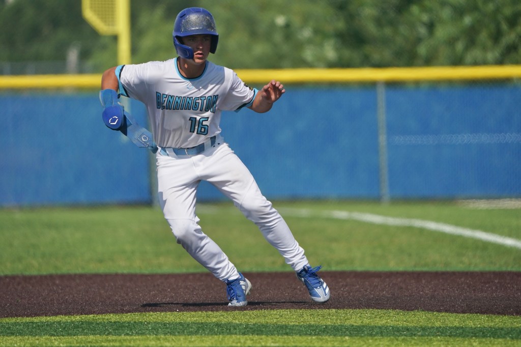 A baseball player running on the field wearing a white uniform with blue accents and the number 16, with a focused expression.