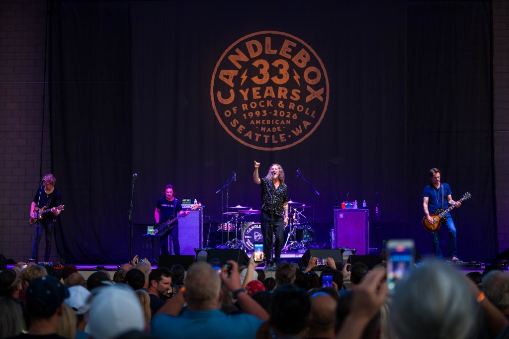 Candlebox band performing on stage during their 33rd anniversary concert in Seattle, with a large crowd enjoying the performance.