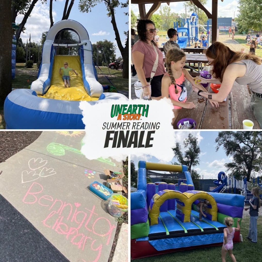 A child slides down a large inflatable water slide at a summer reading event.
