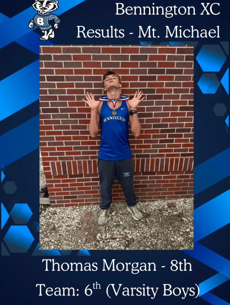 A young male athlete celebrating with his arms raised, wearing a blue cross country jersey with a medal around his neck, standing in front of a brick wall. Text overlay indicates he is Thomas Morgan, 8th place in a varsity boys team event.