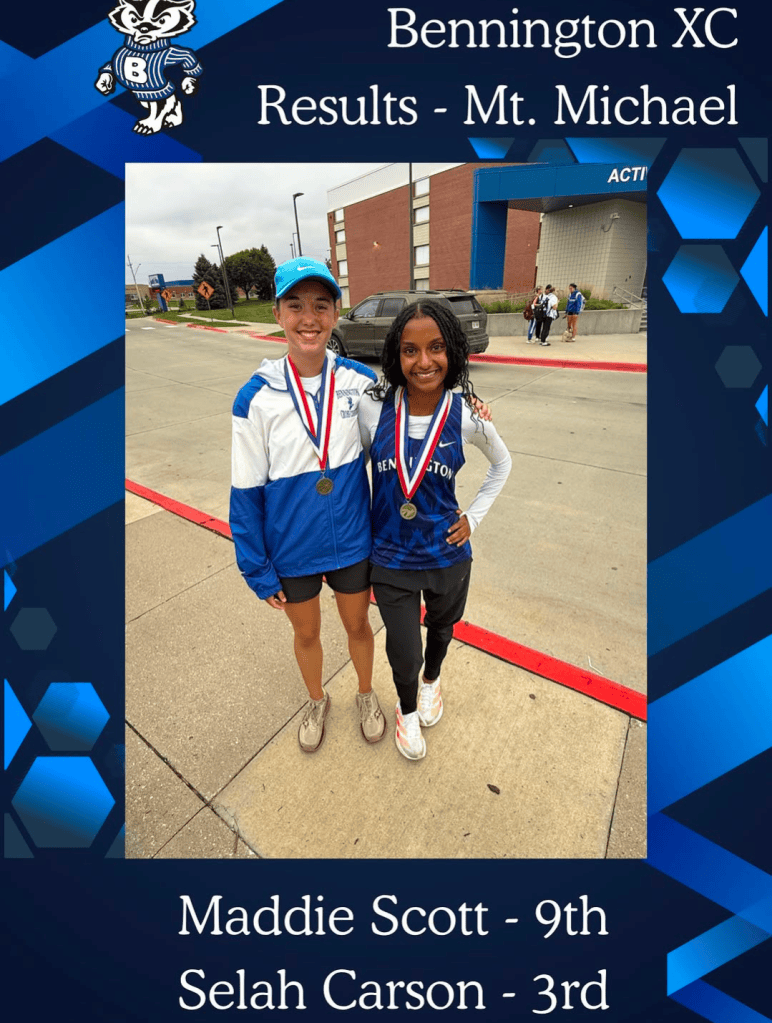 Maddie Scott and Selah Carson, wearing medals, stand together outdoors after a cross country event. Maddie placed 9th and Selah placed 3rd.